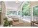 Inviting covered porch with comfortable seating and a ceiling fan overlooking a lush green yard at 8605 Stanton Pl, Raleigh, NC 27615