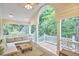 Inviting covered porch with comfortable seating and a ceiling fan overlooking a lush green yard at 8605 Stanton Pl, Raleigh, NC 27615