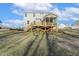 Back exterior featuring a wooden deck with stairs and a screened-in porch, overlooking the spacious backyard at 87 Browning Mill Dr, Wendell, NC 27591