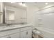 Bright bathroom featuring double vanity with granite counters, large mirror, and shower-tub combination at 87 Browning Mill Dr, Wendell, NC 27591