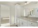 Bright bathroom featuring a granite countertop, large mirror, and wood-look floor at 87 Browning Mill Dr, Wendell, NC 27591