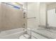 Bright bathroom featuring a tub/shower, granite vanity, and neutral tile at 87 Browning Mill Dr, Wendell, NC 27591