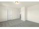 Empty bedroom with neutral carpet, white walls, trim, and two white doors, showing a spacious layout at 87 Browning Mill Dr, Wendell, NC 27591