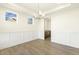 Elegant dining room with hardwood floors, modern lighting, and wainscoting at 87 Browning Mill Dr, Wendell, NC 27591