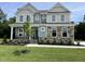 Charming two-story home featuring a landscaped yard, stone accents, and a welcoming front porch at 87 Browning Mill Dr, Wendell, NC 27591