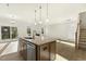 Open-concept kitchen with an island, stainless steel appliances, and seamless flow to the living area at 87 Browning Mill Dr, Wendell, NC 27591