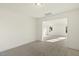 This room features neutral carpet and is adjacent to another bright room, creating a seamless and inviting space at 87 Browning Mill Dr, Wendell, NC 27591