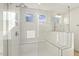 Elegant shower with white subway tile, glass door, and built-in bench seating at 87 Browning Mill Dr, Wendell, NC 27591