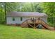 Exterior view of home's backyard showing a deck with steps leading to the yard at 8812 Valley Hill Ct, Apex, NC 27539
