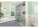 Modern bathroom featuring a glass shower, white marble vanity, and stylish patterned floors at 8812 Valley Hill Ct, Apex, NC 27539
