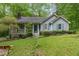 Cozy one-story home with a well-maintained lawn, vibrant blue shutters, and a welcoming covered porch at 8812 Valley Hill Ct, Apex, NC 27539