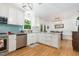 Open-concept kitchen with stainless appliances, island, white cabinets, and eat-in dining area at 8812 Valley Hill Ct, Apex, NC 27539