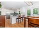 Bright kitchen with white cabinetry, stainless steel appliances, a peninsula with seating, and hardwood flooring at 8812 Valley Hill Ct, Apex, NC 27539