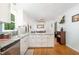 Bright kitchen offers stainless appliances, island, white cabinets, and dining area at 8812 Valley Hill Ct, Apex, NC 27539