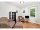 Cozy living room with hardwood floors, a window, and comfortable seating arrangement at 8812 Valley Hill Ct, Apex, NC 27539
