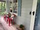 Inviting porch with seating, flower pots, and light blue siding, great for relaxing and enjoying the outdoors at 8812 Valley Hill Ct, Apex, NC 27539