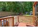 Backyard area with a wooden deck overlooking a lawn, play set, and wooded surroundings at 9300 Glendora Ct, Garner, NC 27529