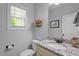 Cozy bathroom with granite countertop, decorative accents, and natural light at 9300 Glendora Ct, Garner, NC 27529