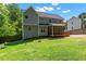 Rear exterior featuring a patio and expansive green space, enhanced by lush trees at 9300 Glendora Ct, Garner, NC 27529