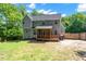 View of the rear of the home, with a wooden deck and a spacious backyard area at 9300 Glendora Ct, Garner, NC 27529