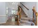 Hallway features hardwood floors, staircase, and dining area with plenty of natural light at 9300 Glendora Ct, Garner, NC 27529