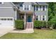 Close-up of the front entrance showcasing the blue door, fresh landscaping, and inviting staircase at 9300 Glendora Ct, Garner, NC 27529