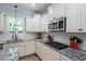 Stylish kitchen showcasing granite countertops, stainless steel appliances, and white cabinets at 9300 Glendora Ct, Garner, NC 27529