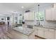 Well-designed kitchen features white cabinets, granite counters, a center island, and stainless appliances at 9300 Glendora Ct, Garner, NC 27529
