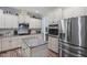 Bright kitchen with granite counters, stainless appliances, white cabinets, and a center island at 9300 Glendora Ct, Garner, NC 27529
