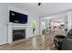 Inviting living room with fireplace, TV, hardwood floors, and open access to the kitchen at 9300 Glendora Ct, Garner, NC 27529