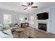 Cozy living room featuring a fireplace, TV, hardwood floors, and comfortable seating at 9300 Glendora Ct, Garner, NC 27529