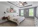 Bedroom featuring shiplap accent wall, tray ceiling, ceiling fan, and carpeted floor at 9300 Glendora Ct, Garner, NC 27529