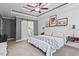Bedroom with tray ceiling, ceiling fan, carpeted floor, shiplap wall, and floating nightstands at 9300 Glendora Ct, Garner, NC 27529