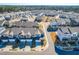 Drone shot showcases a residential neighborhood with neatly arranged homes, trees and paved streets at 931 Haybeck Ln, Apex, NC 27523