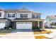 Charming two-story home with a brick facade, a two-car garage, and a well-manicured lawn at 931 Haybeck Ln, Apex, NC 27523
