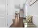 Bright foyer with dark hardwood floors, white walls, and a staircase leading to the upper level at 931 Haybeck Ln, Apex, NC 27523