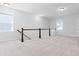 Upstairs hallway with neutral carpet, white walls, and dark wood banister at 931 Haybeck Ln, Apex, NC 27523