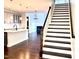Open-concept home showcasing the staircase with white risers and dark treads, connecting multiple floors at 931 Haybeck Ln, Apex, NC 27523