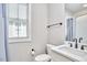 Modern bathroom with white countertop, toilet, window and black hardware at 941 W Club Blvd, Durham, NC 27701