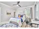 Comfortable bedroom with a large bed, desk, and a ceiling fan for added comfort at 941 W Club Blvd, Durham, NC 27701