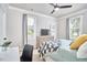Bright bedroom with two windows, ceiling fan, desk and black and white bedding at 941 W Club Blvd, Durham, NC 27701
