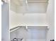 Walk in closet with built-in shelving and bars for ample storage at 941 W Club Blvd, Durham, NC 27701