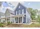 Charming blue two-story home with a welcoming front porch and well-manicured lawn at 941 W Club Blvd, Durham, NC 27701