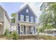 Charming blue two-story home with a welcoming front porch and well-manicured lawn at 941 W Club Blvd, Durham, NC 27701