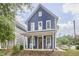 Inviting blue two-story home with rocking chairs on the charming front porch at 941 W Club Blvd, Durham, NC 27701