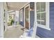 Inviting front porch featuring rocking chairs and a stylish wood door at 941 W Club Blvd, Durham, NC 27701