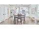 Bright kitchen featuring white cabinets, stainless steel appliances, and a dining table at 941 W Club Blvd, Durham, NC 27701