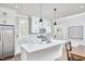 Bright kitchen features white cabinets, stainless steel appliances, and a large center island at 941 W Club Blvd, Durham, NC 27701