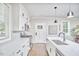 Bright kitchen features white cabinets, stainless steel appliances, and a large center island at 941 W Club Blvd, Durham, NC 27701
