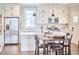Elegant kitchen featuring white cabinets, stainless steel refrigerator, and a center island at 941 W Club Blvd, Durham, NC 27701